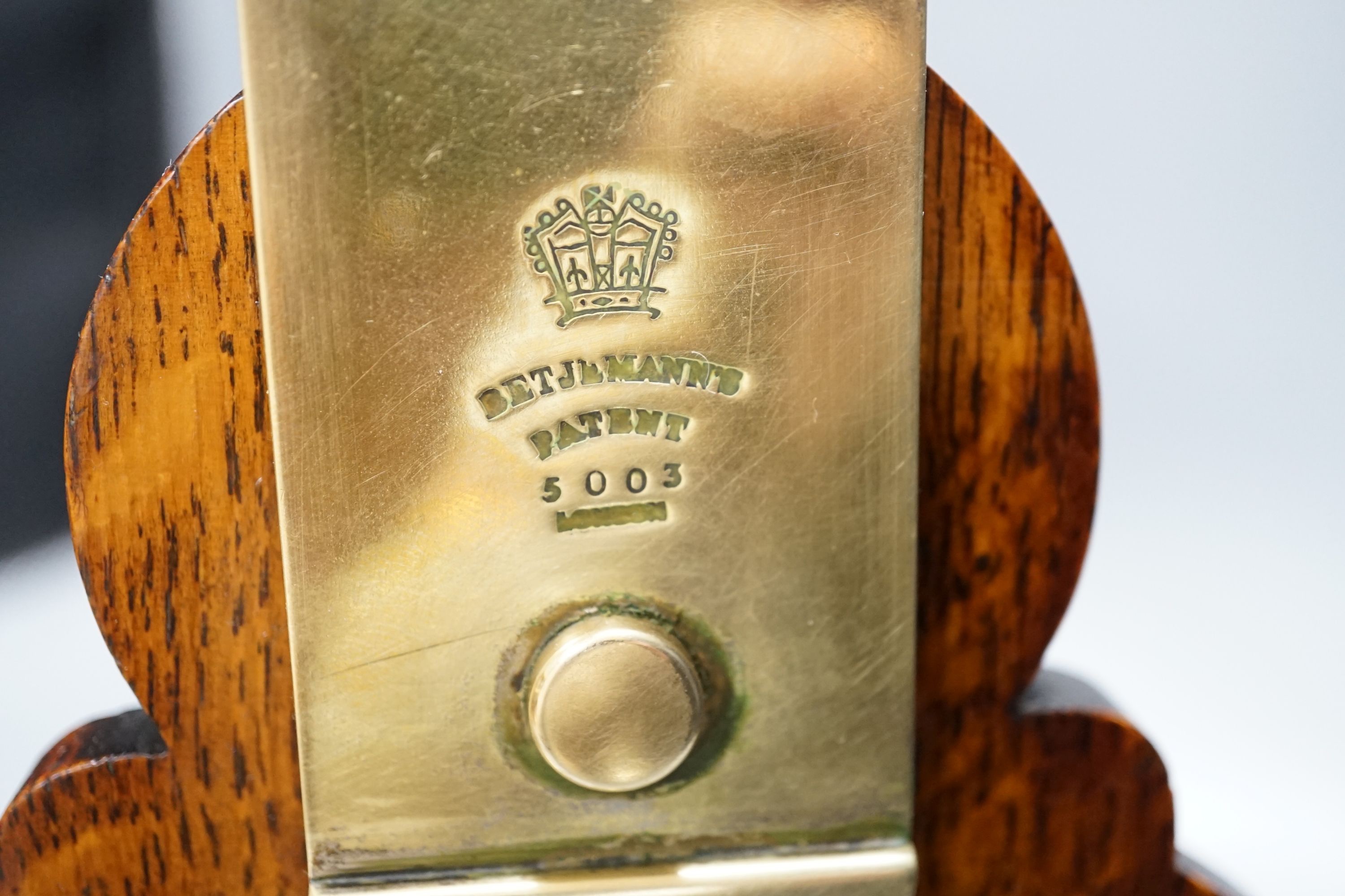 A Victorian Betjemann Patent oak three-bottle Tantalus - 34.5cm high